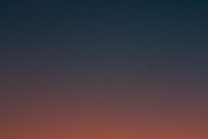 Fiery sunset with crescent moon Crescent moon and fiery orange sunset horizon